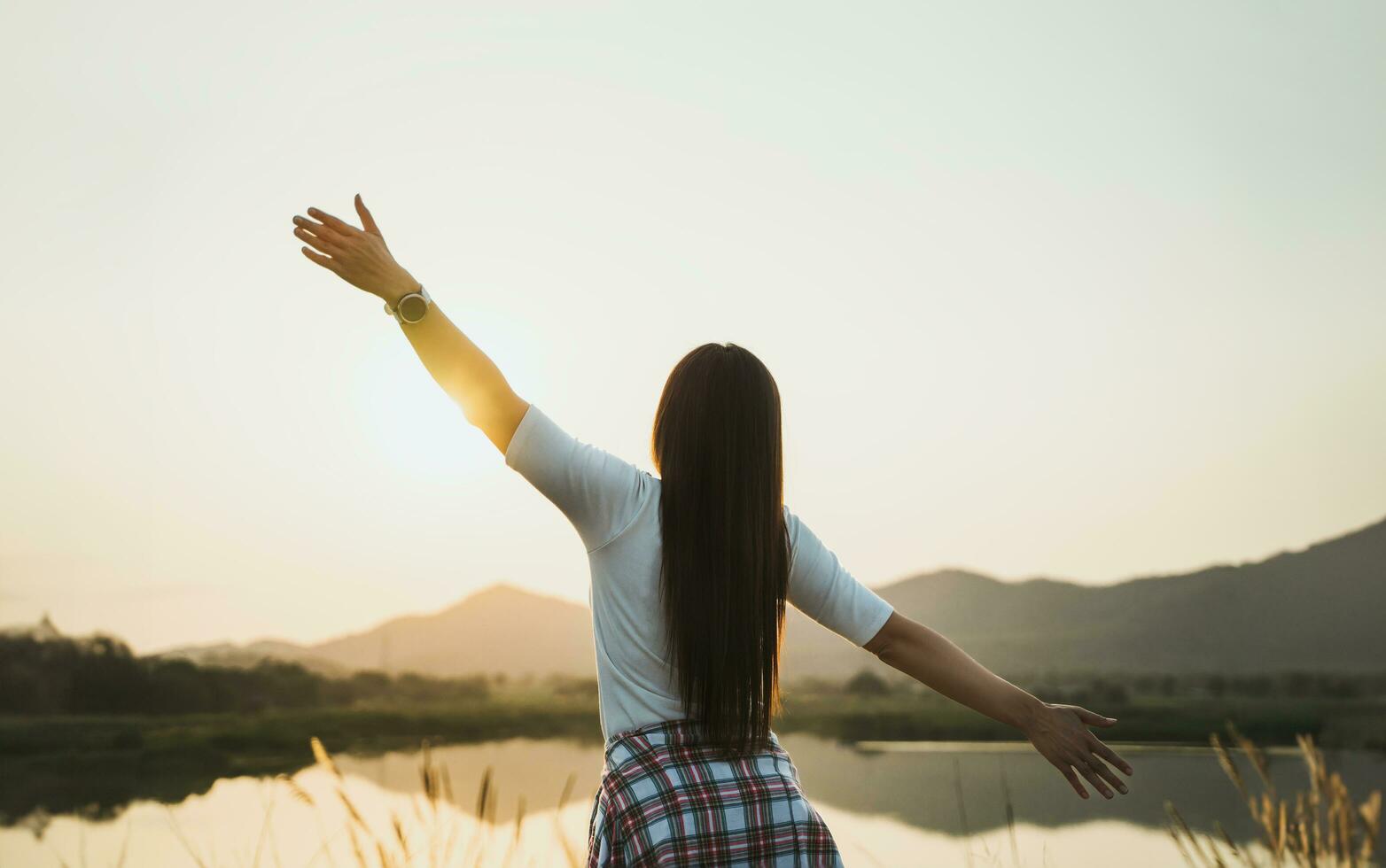 Happy woman spreading arms and watching the mountain. Travel Lifestyle success concept adventure active vacations outdoor freedom emotions. photo