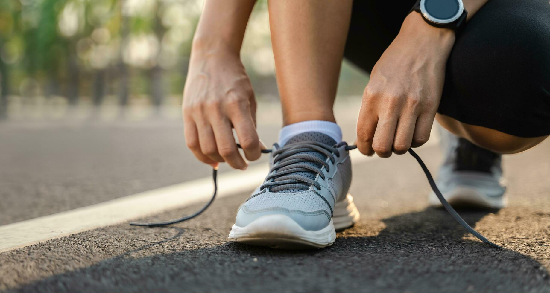 closeup of young woman runner tying her shoelaces. healthy and fitness concept. photo