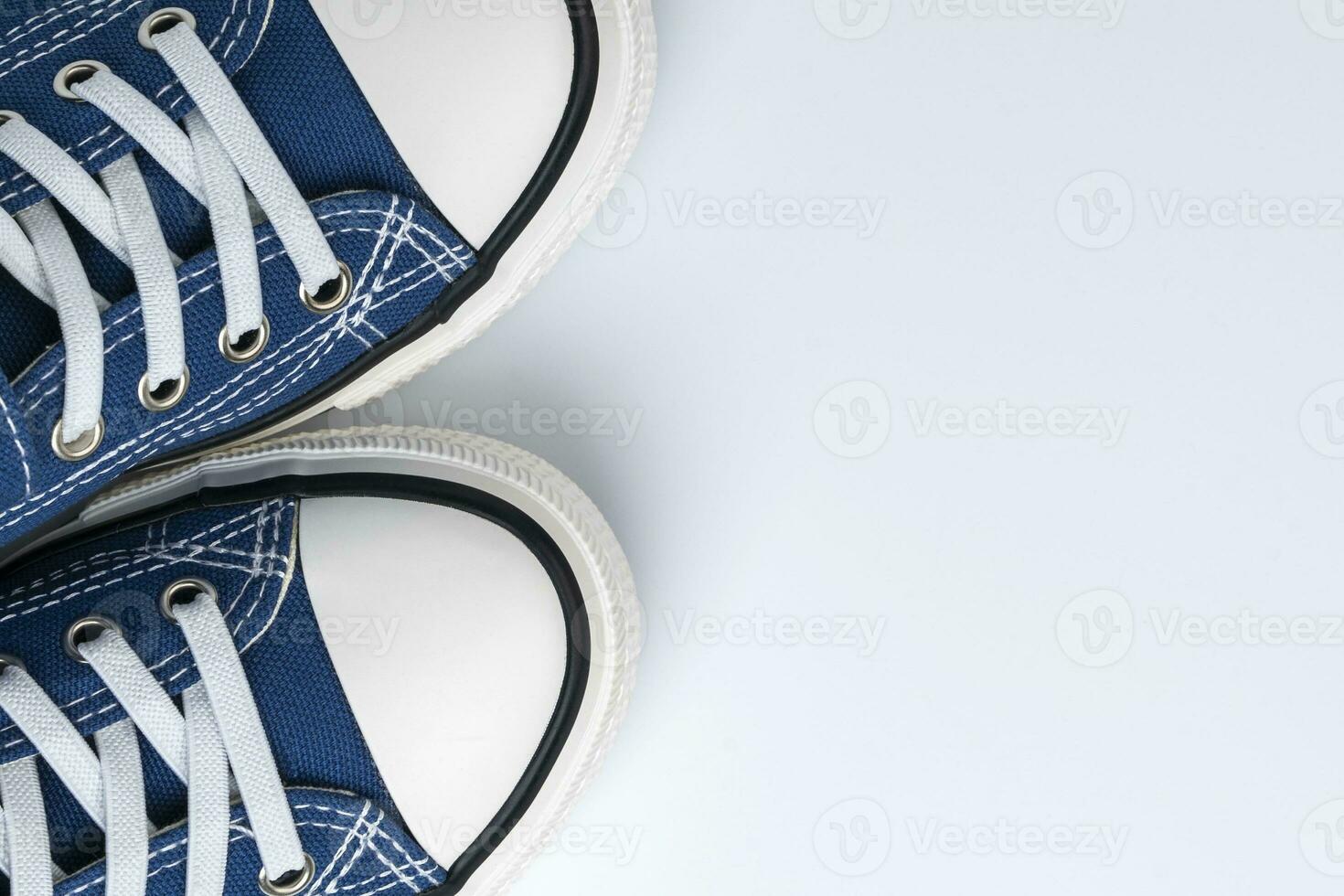 a pair of blue sneakers on a white background. Fashionable youth shoes photo