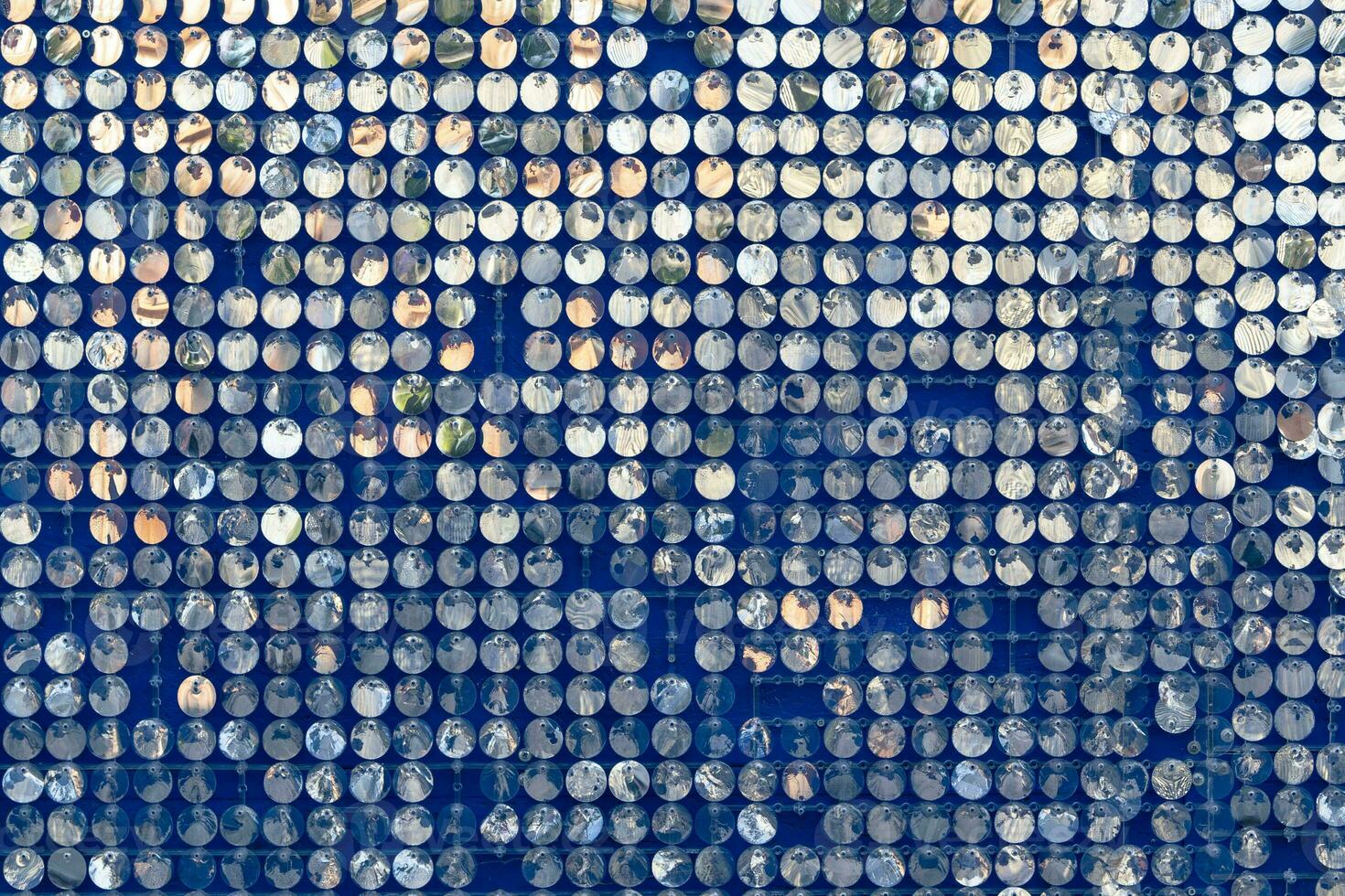 abstract background of silver disks suspended on strings. sparkling photo