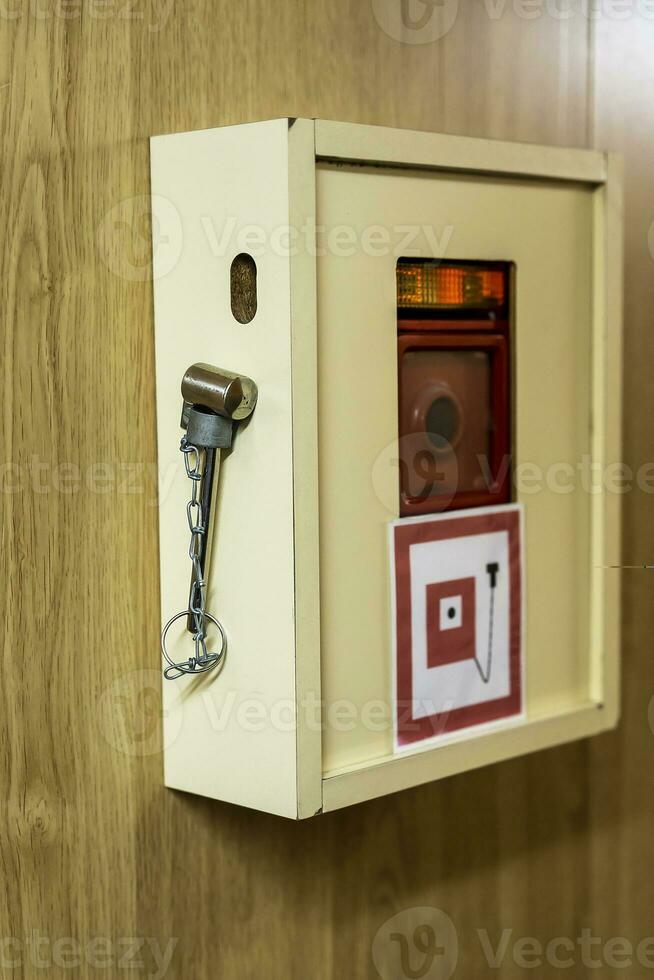 the red fire alarm button on the ship and a hammer photo