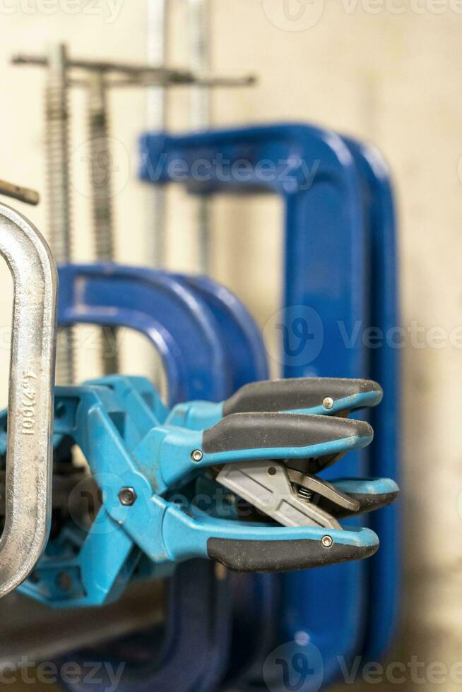 hand clamps on the welding table in the auto repair shop photo