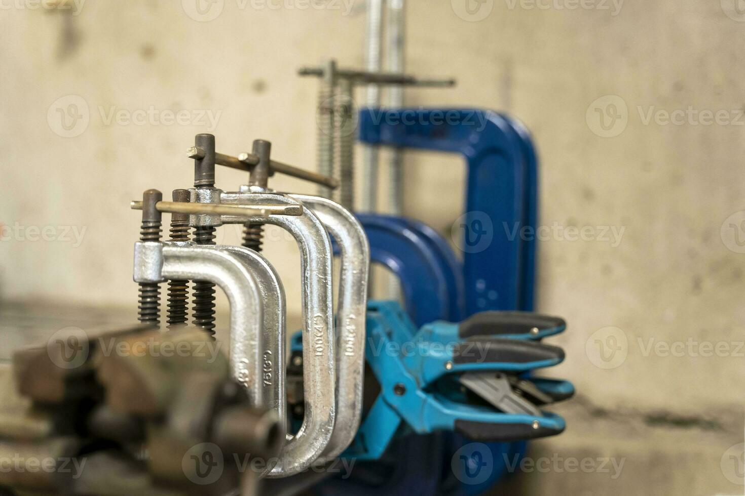 hand clamps on the welding table in the auto repair shop photo