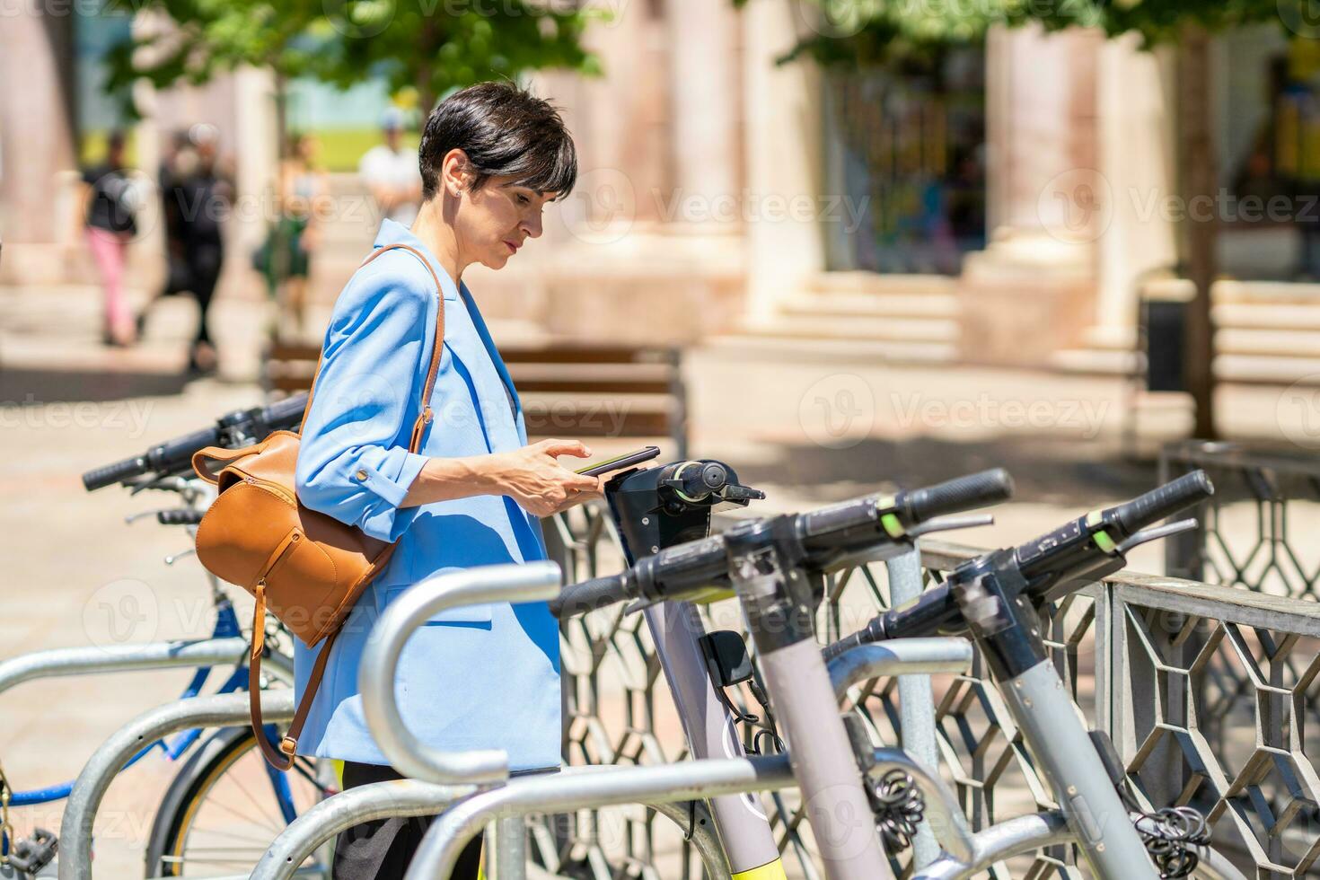 Pensive woman using kick sharing photo