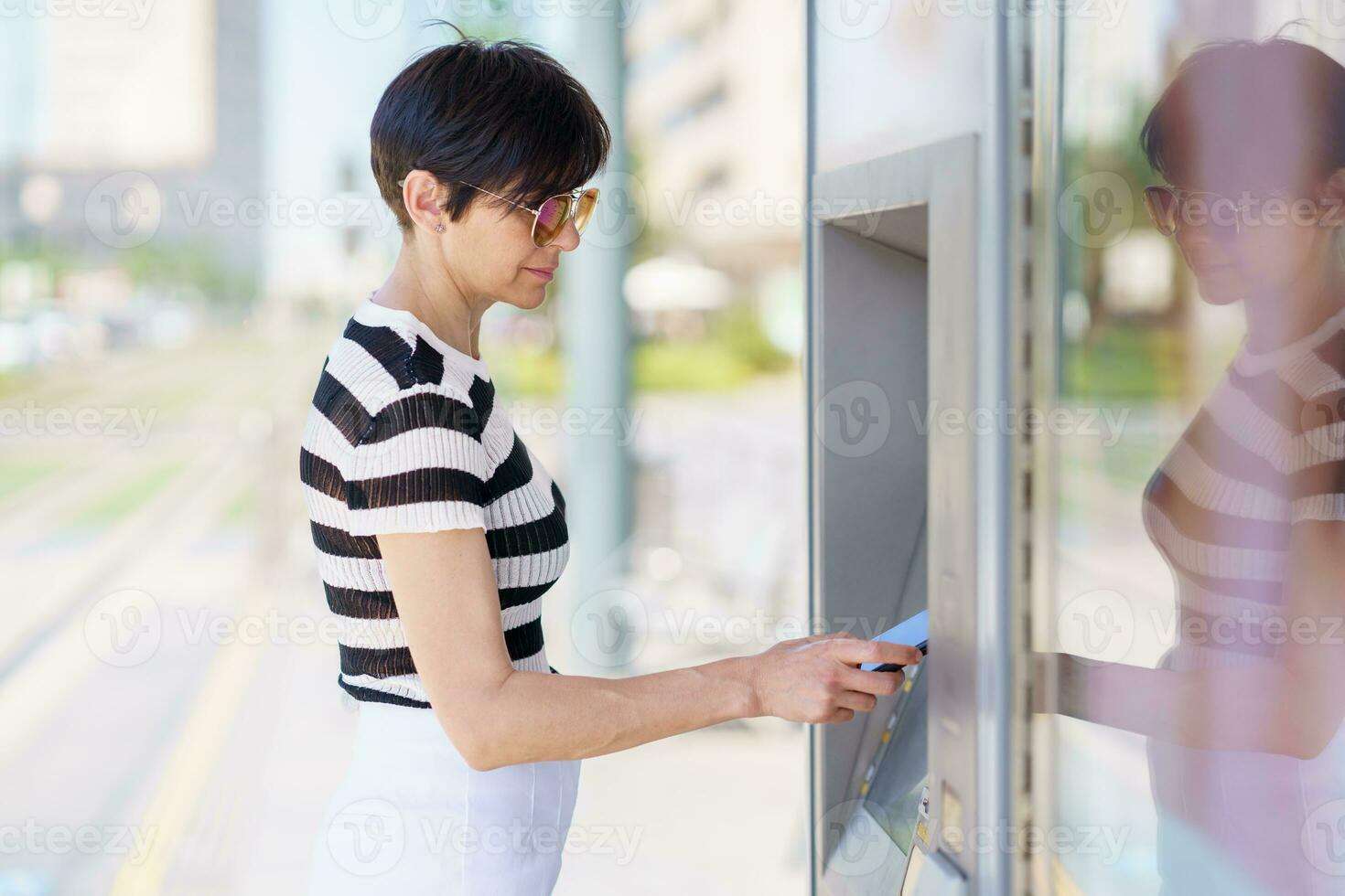 Focused woman paying for purchase with smartphone photo