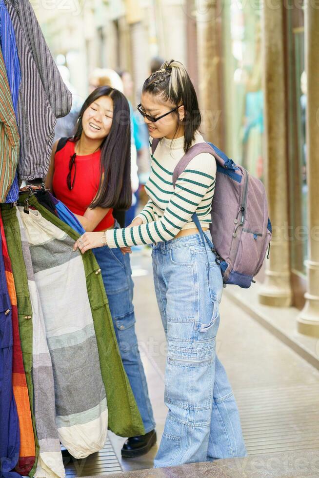 Happy girl with friend shopping on street market photo
