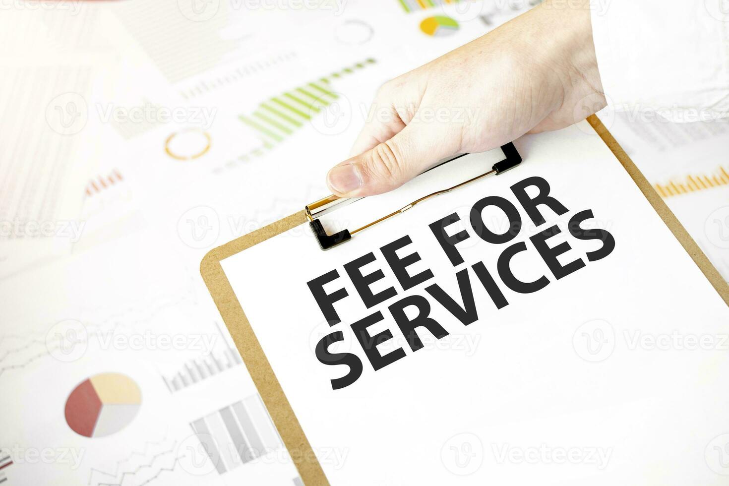 Text fee for services on white paper plate in businessman hands with financial diagram. Business concept photo