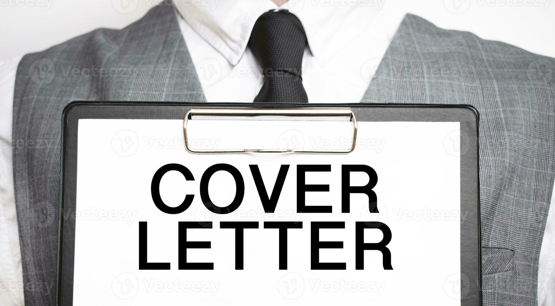 Businessman holding sheet of paper with a message COVER LETTER photo