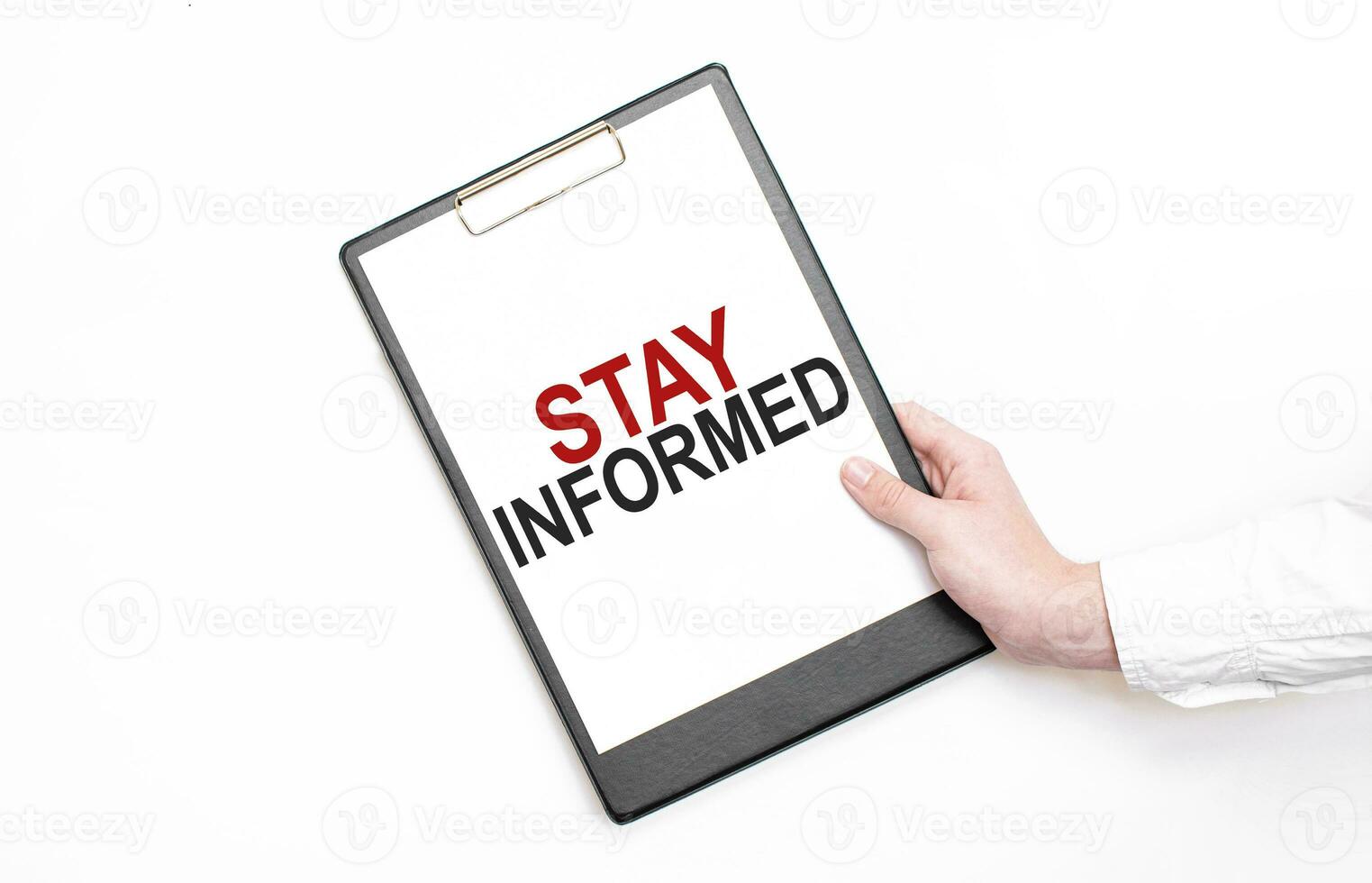 A businessman holds a folder with paper sheet with the text STAY INFORMED. Business concept. photo