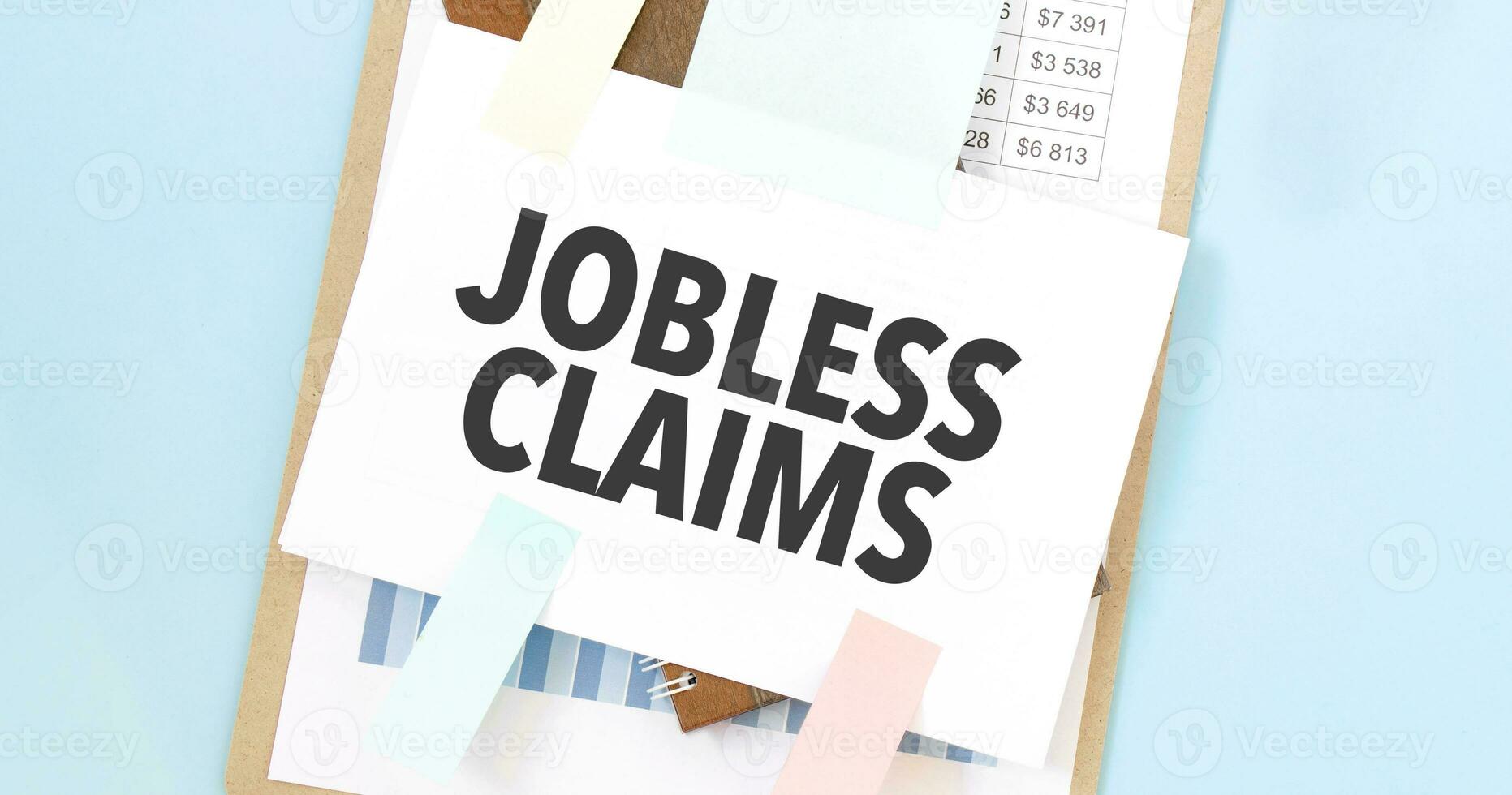 Paper plate with text take JOBLESS CLAIMS. Diagram, notepad and blue ...