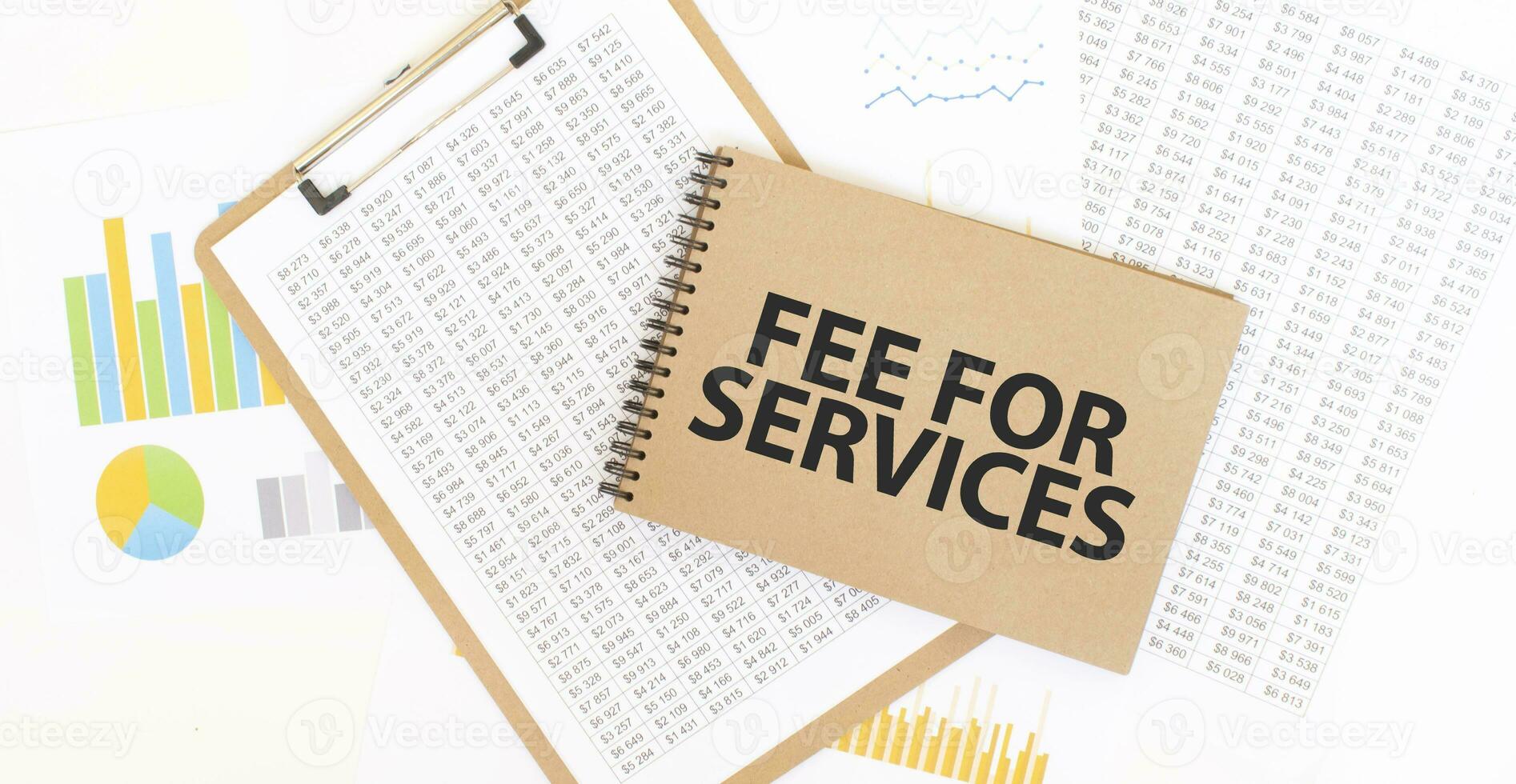 Text fee for services on brown paper notepad on the table with diagram. Business concept photo