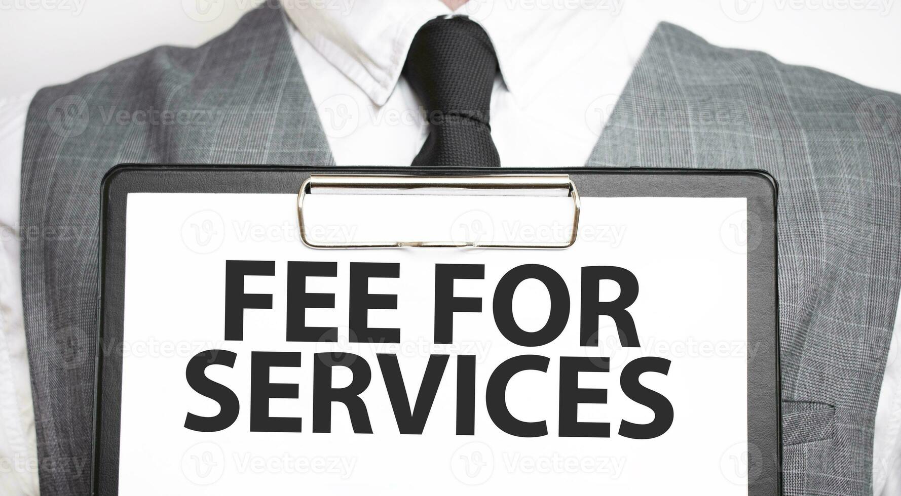 Businessman holding sheet of paper with a message fee for services photo