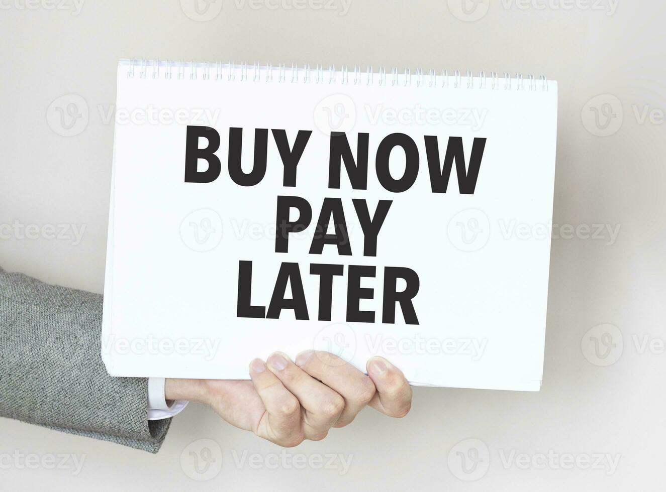 Businessman holding a card with text buy now pay later photo