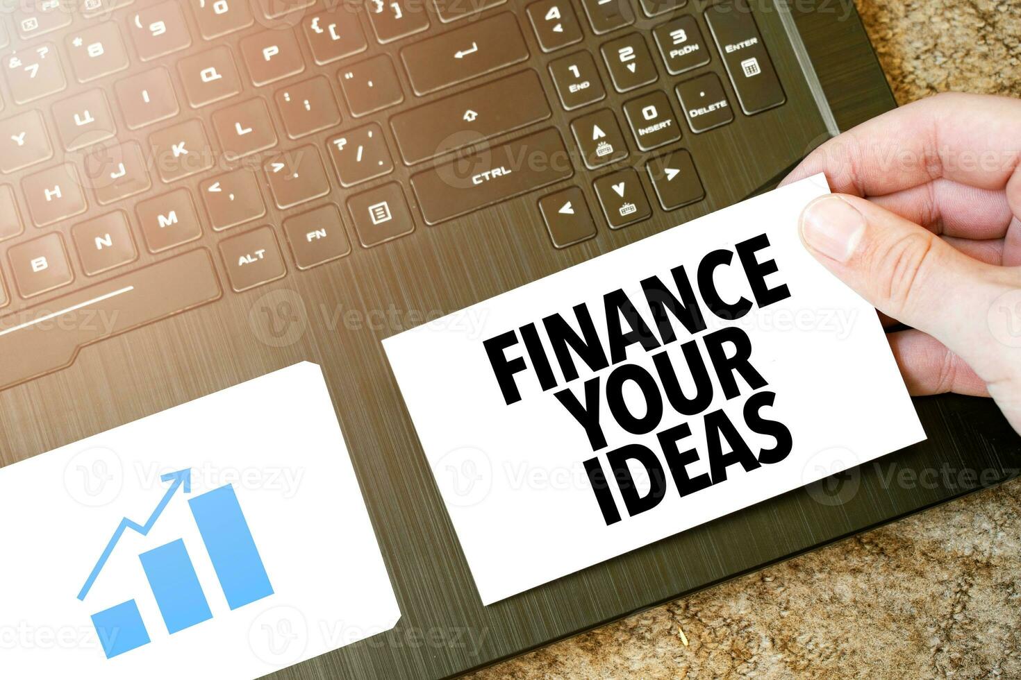 Calculator, red notepad, three colour pencils, silver pen and brown notebook with text FINANCE YOUR IDEAS photo