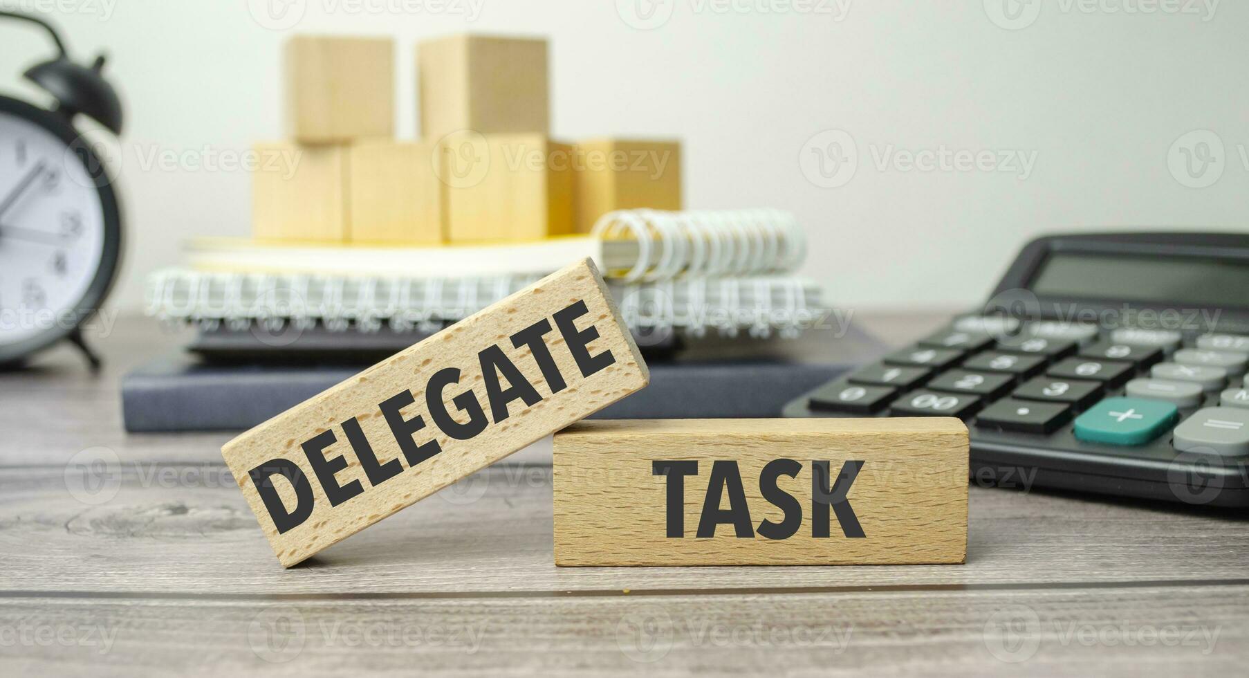 delegate task is shown on a conceptual photo using wooden blocks