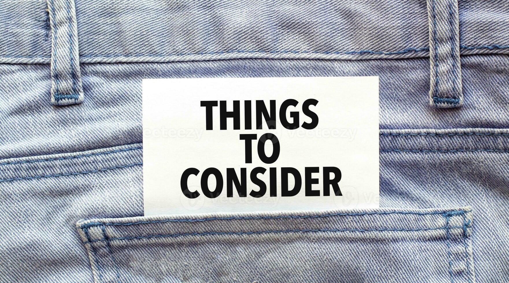 Text things to consider on a white paper stuck out from jeans pocket. Business concept photo