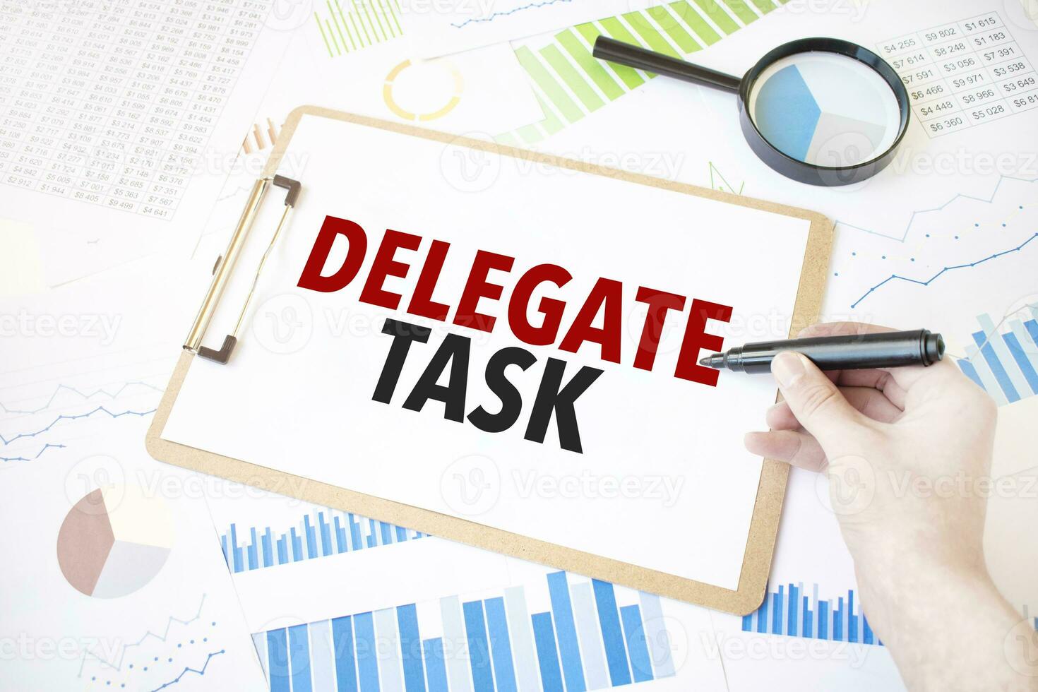 Text delegate task on white paper sheet and marker on businessman hand on the diagram. Business concept photo