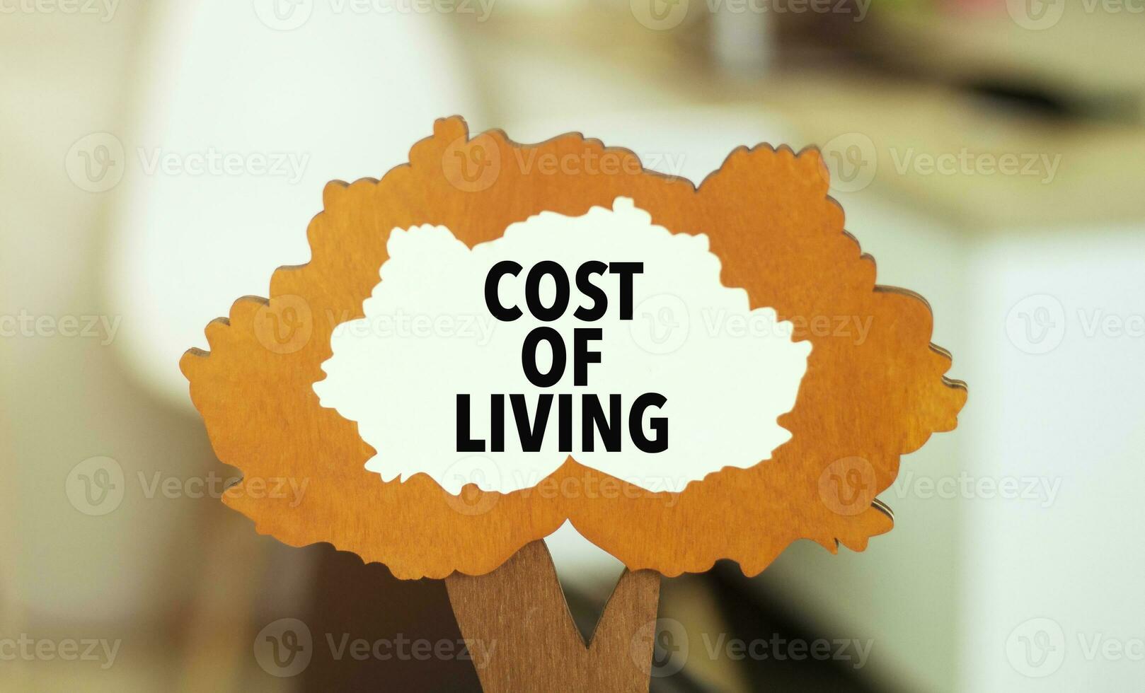figure of a tree with text cost of living inside the foliage. Business concept photo