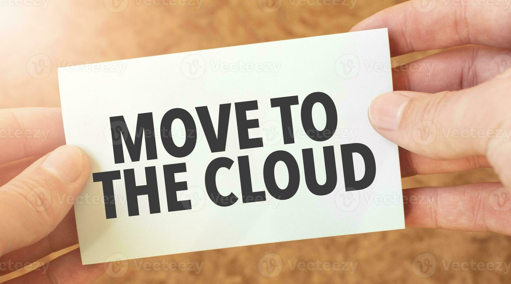 MOVE TO THE CLOUD word inscription on white card paper sheet in hands of a businessman. recap concept. red and white paper photo
