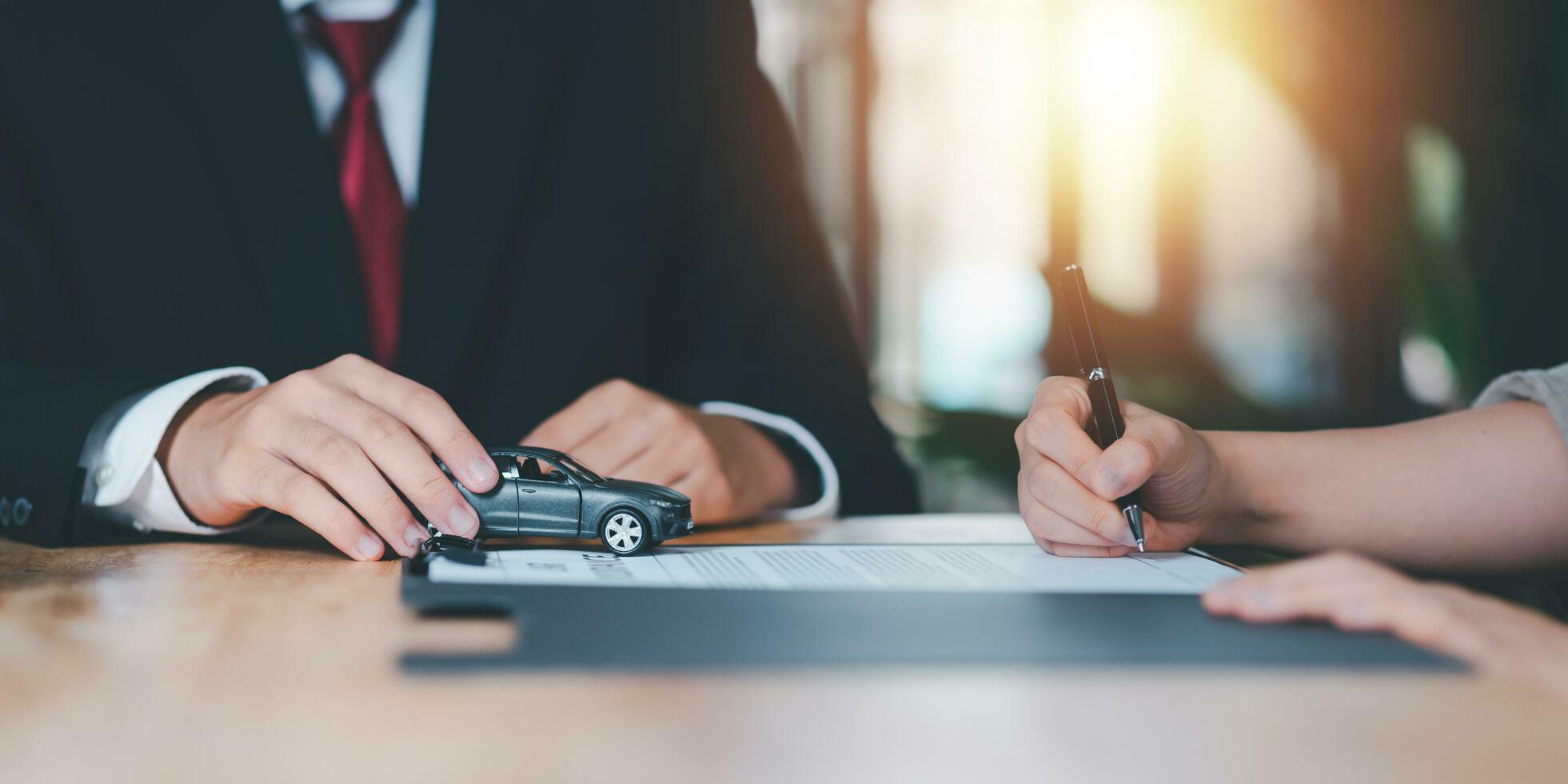 car purchase agreement ,Providing financial services and car insurance ,financial car loans ,Lease agreement or lease concept ,Customers sign insurance documents or car rental forms photo