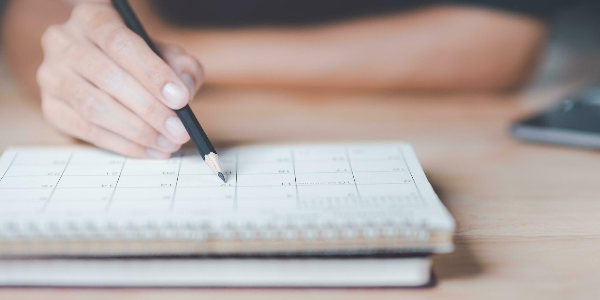 Strategic Planning Concepts, brainstorm ideas on business plans, Updating schedules or planning business, teamwork and data analysis, marketing development, This male hand at the calendar to schedule photo