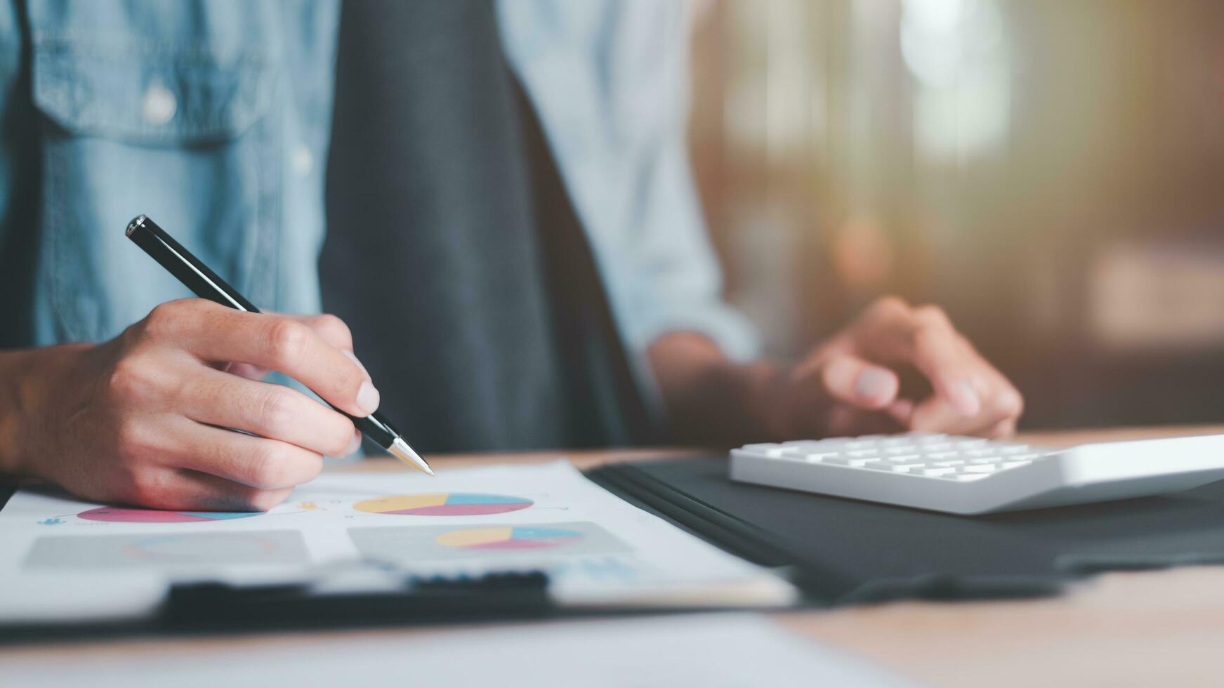 statistical analyst using calculator to calculate and read reports, graphs and charts, business statistics ,Analysis and improvement of corporate strategy ,Statistics and Data Concepts photo