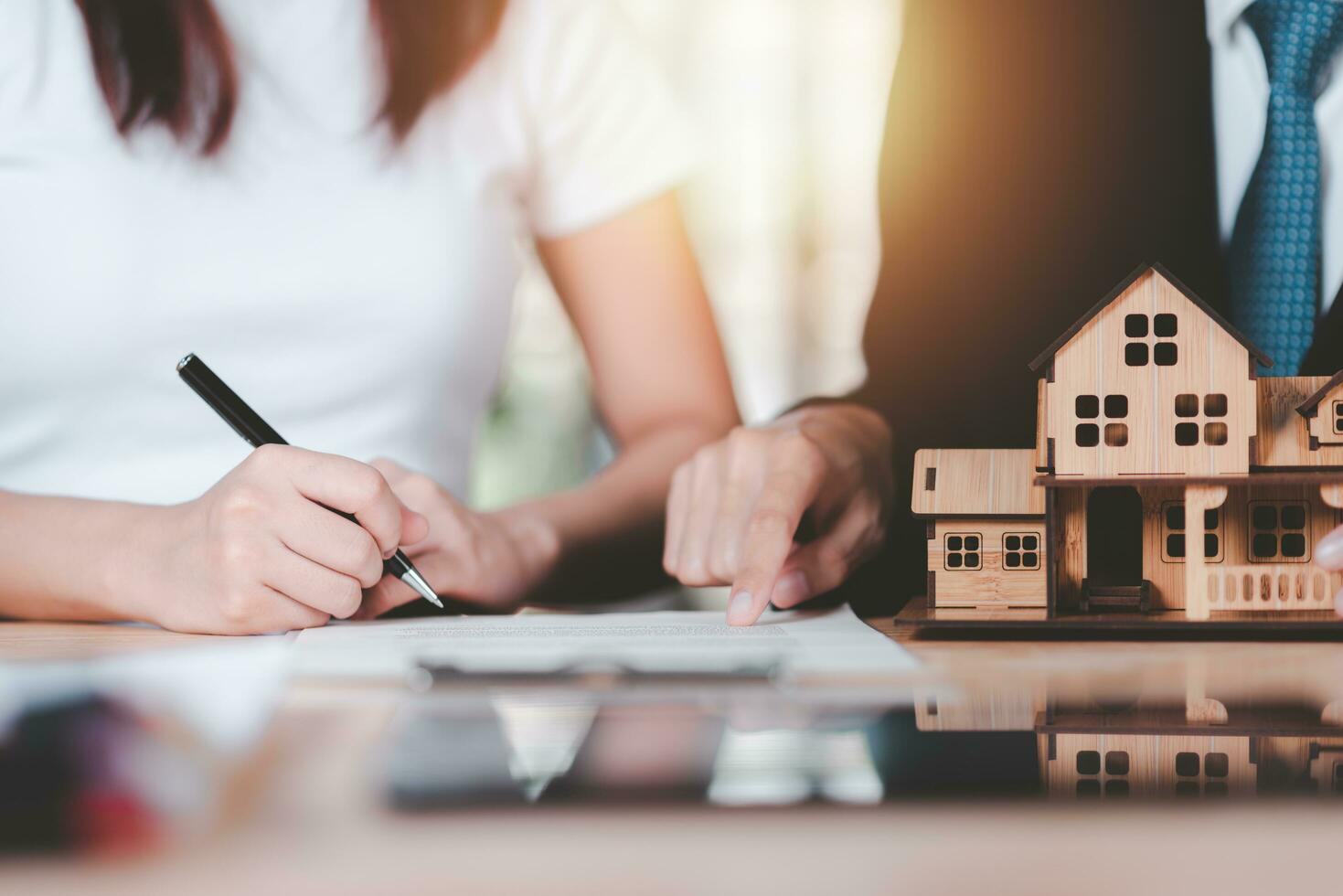 customer checking loan agreement with real estate agent ,Investment loan approval concepts to build residential homes, real estate business ,appraisal of property value ,Signing to approve contract photo
