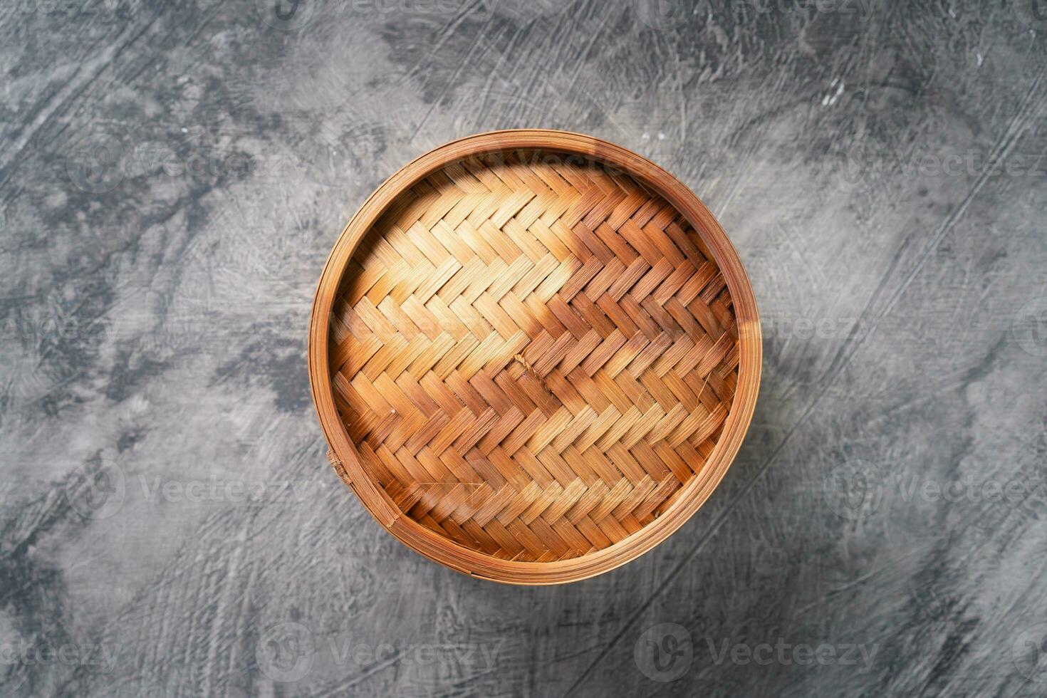 Chinese steamed dumplings or  Dim Sum in bamboo steamer on dark abstract background photo