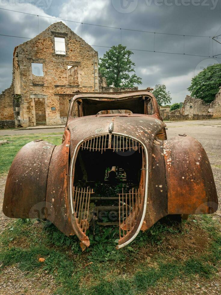 Old rusty cars left behind in Oradour-sur-Gllane, France. photo