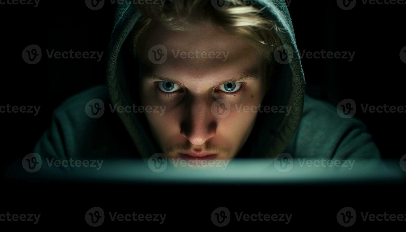 Hooded computer hacker stares at monitor in darkness generated by AI photo