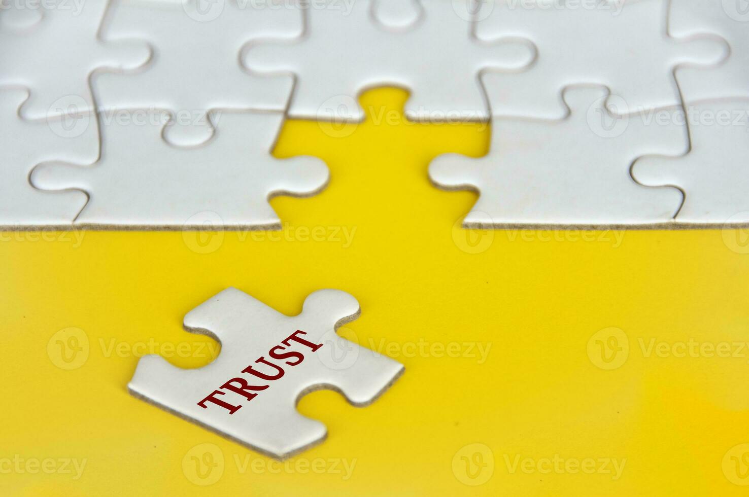 Trust text on missing jigsaw puzzle on yellow background photo
