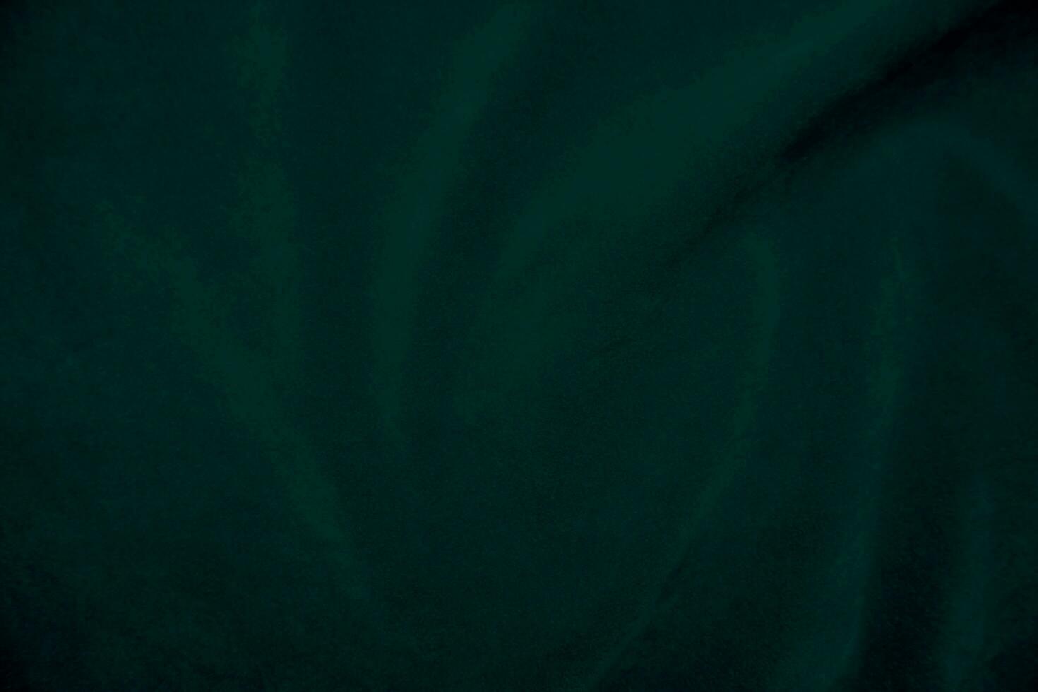 Green velvet fabric texture used as background. Empty green fabric