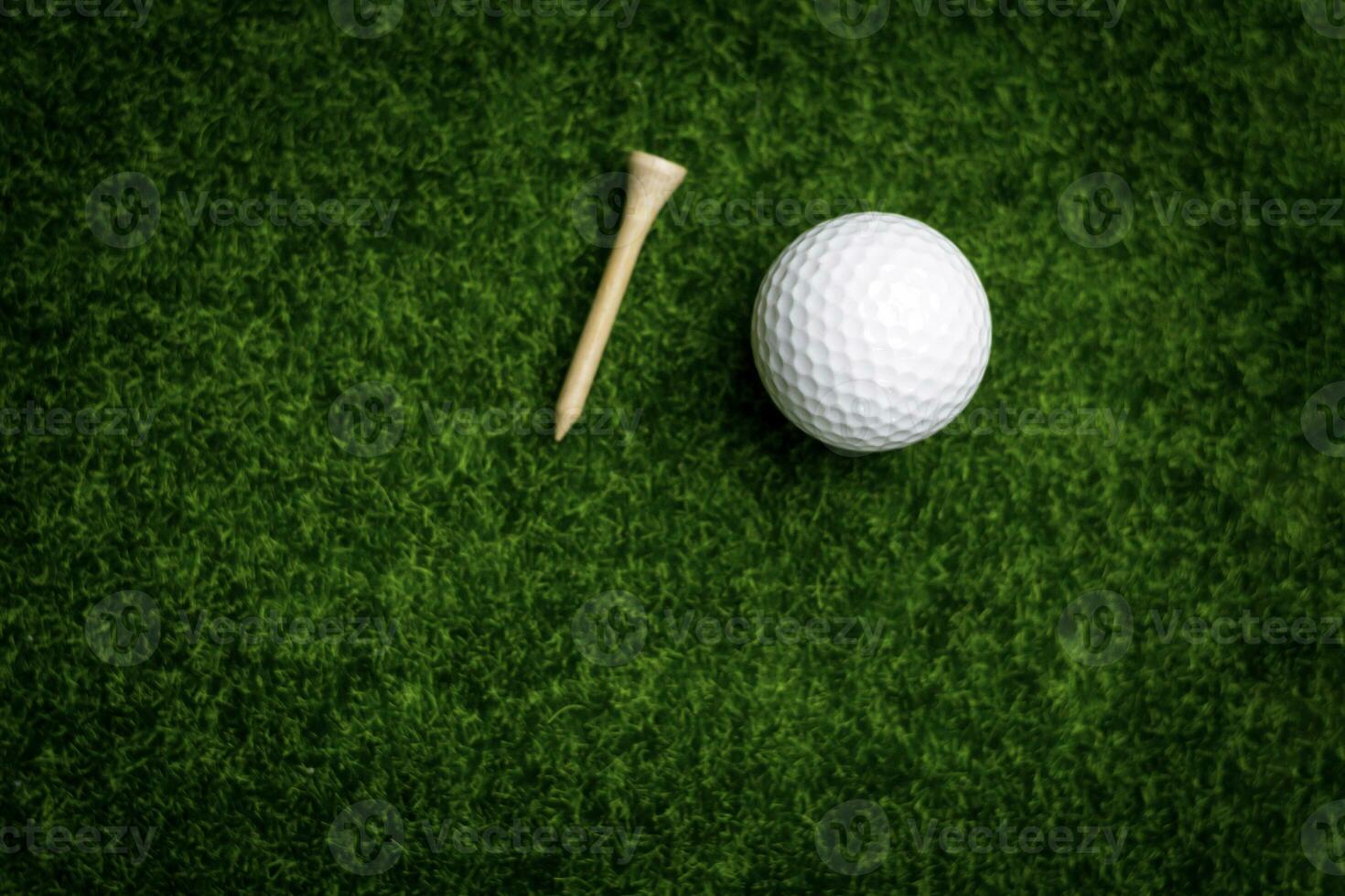 Golf ball close up on tee grass on blurred beautiful landscape of golf background. Concept international sport that rely on precision skills for health relaxation. photo