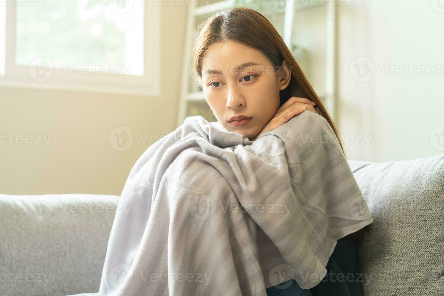 Sad, unhappy. Alone asian young woman, girl expression face thinking about problem, difficulty, feeling failure and exhausted, suffering sitting on sofa, grief sorrow and bad relationship or break up. photo