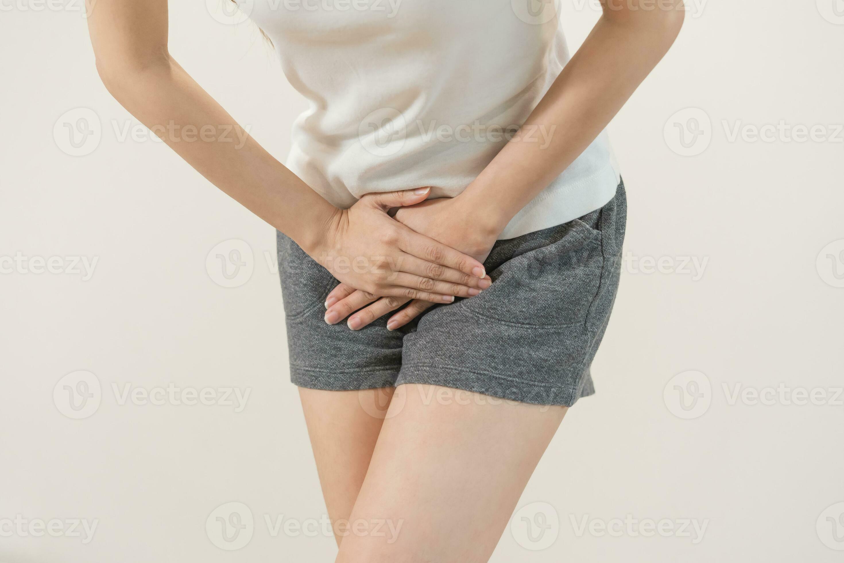 Vaginal, urinary incontinence. Pain asian young woman hand holding