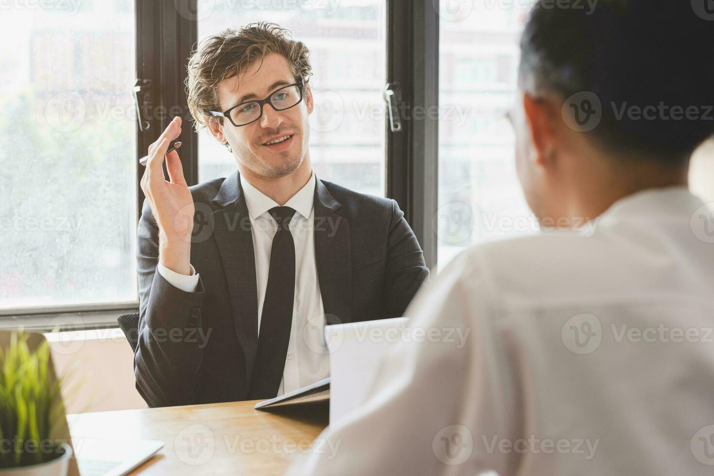 Asian young manager, employer man interview with person, have question about resume and listen to candidate answer, conversation together at office. Recruitment employee job concept. photo