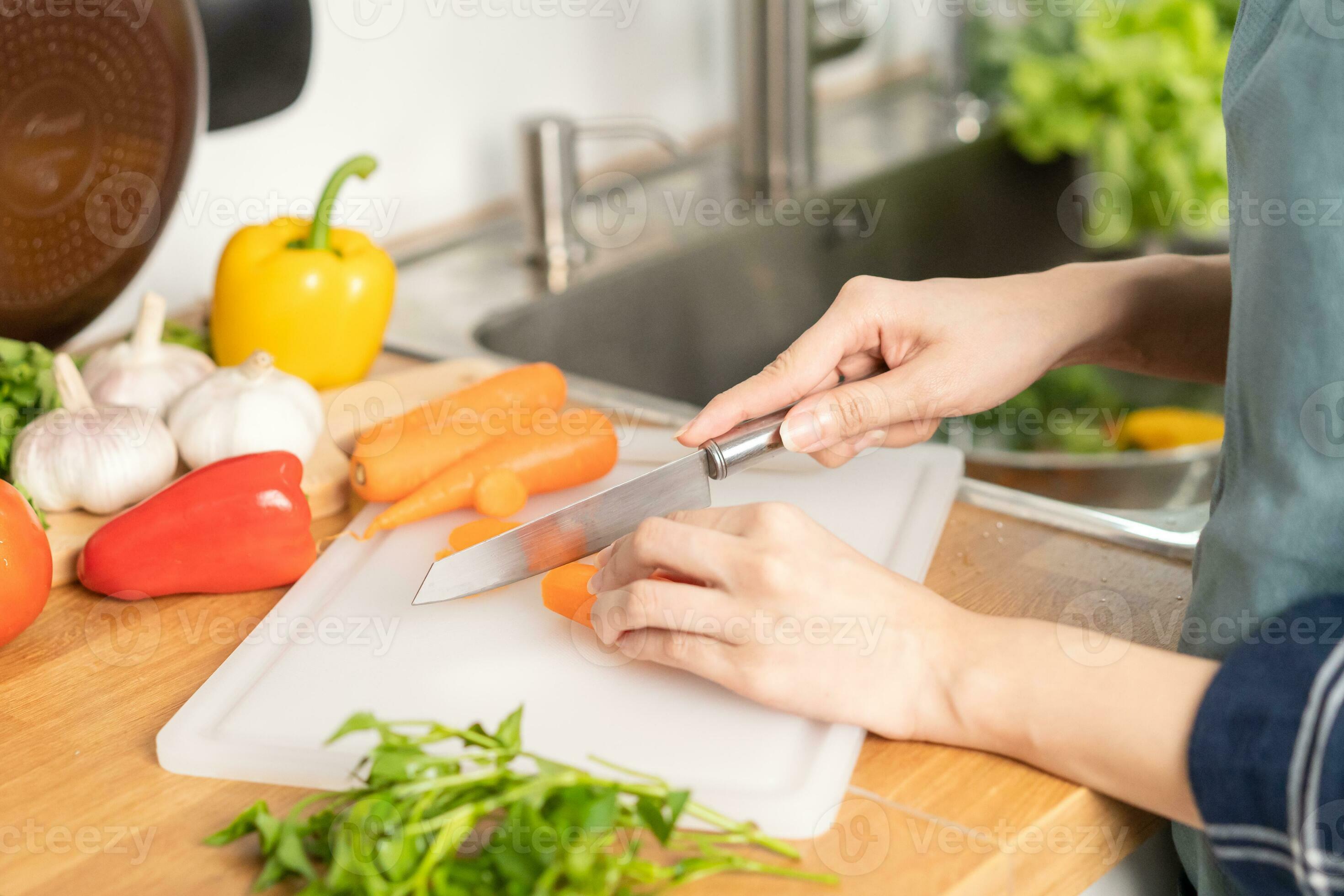 Fresh vegetables on woden cutting board with knife