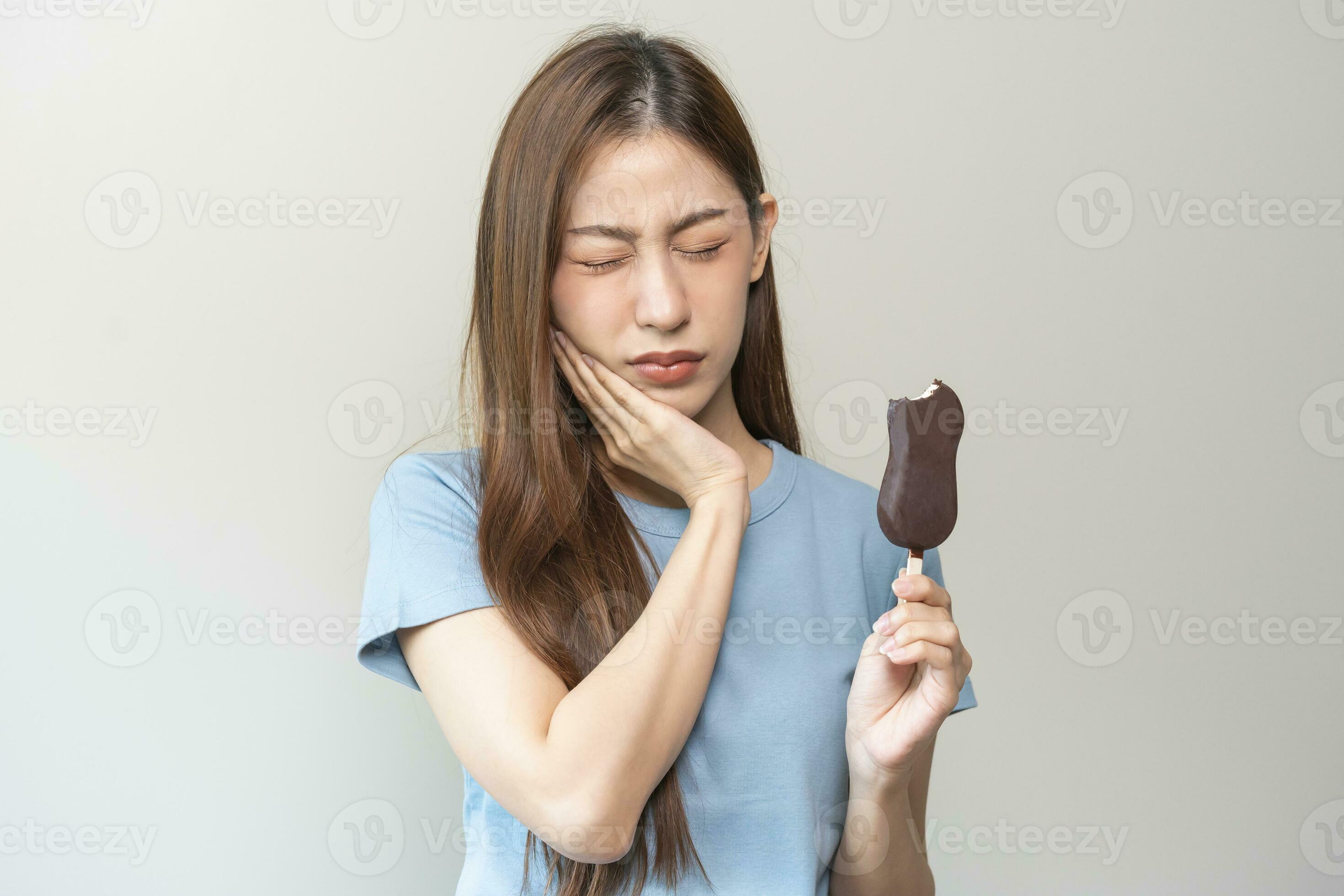 Face expression suffering from sensitive teeth and cold, asian young