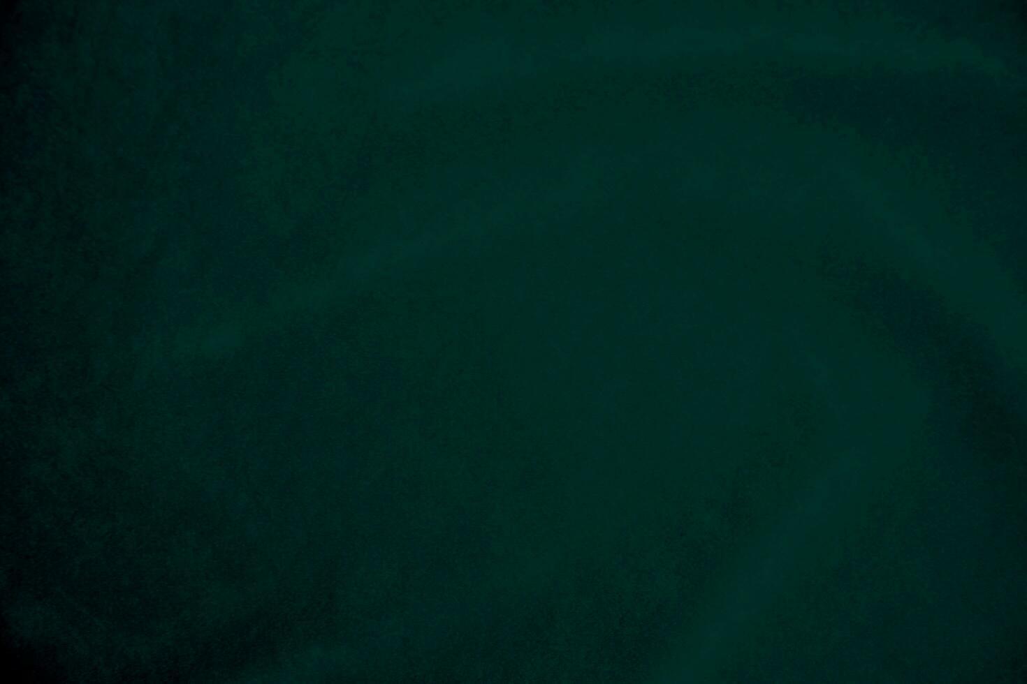 Green velvet fabric texture used as background. Empty green fabric