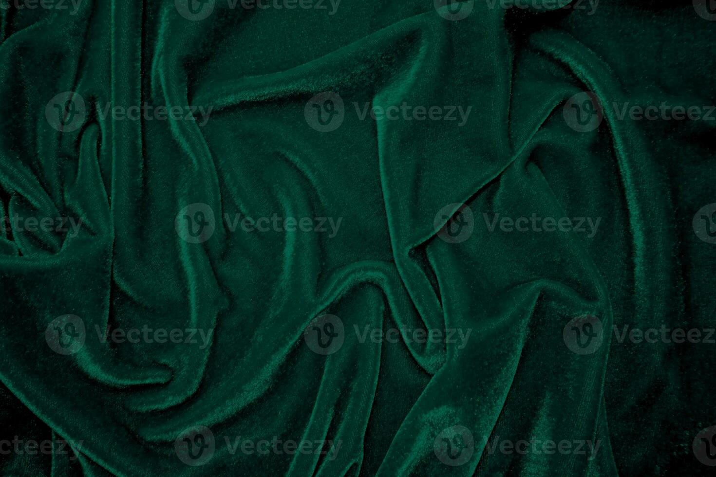 Green velvet fabric texture used as background. Peacock color panne fabric background of soft and smooth textile material. crushed velvet .luxury emerald tone for silk. photo