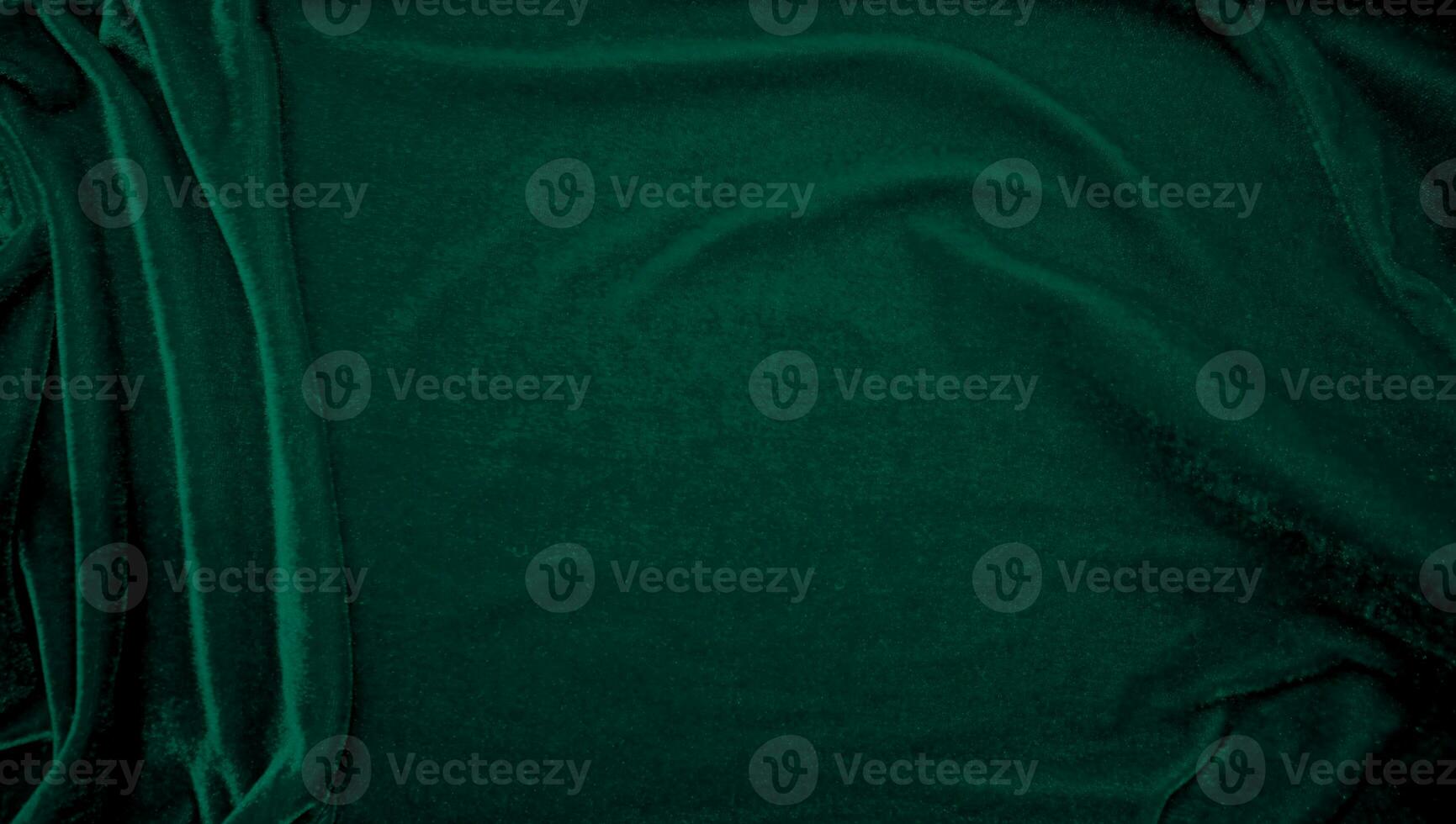 Green velvet fabric texture used as background. Peacock color panne fabric background of soft and smooth textile material. crushed velvet .luxury emerald tone for silk. photo