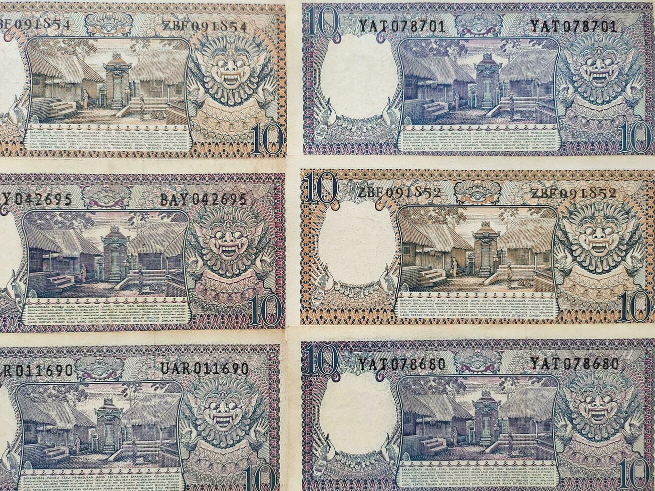 Portrait of old Indonesian banknotes Rp.10,00 rupiah issued in 1963. Old rupiah currency conceptual, top view photo