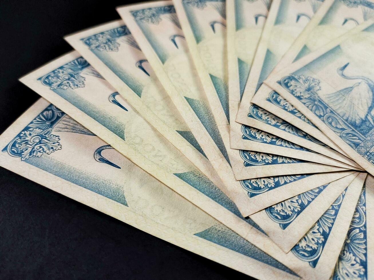 Close up view of old Indonesian banknotes Rp.500 rupiah issued in 1992. Old rupiah currency concept isolated on a black background. photo