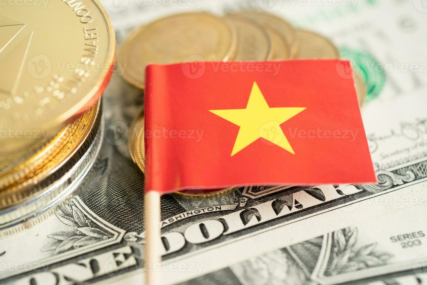 Stack of coins with Vietnam flag and US dollar banknotes. photo