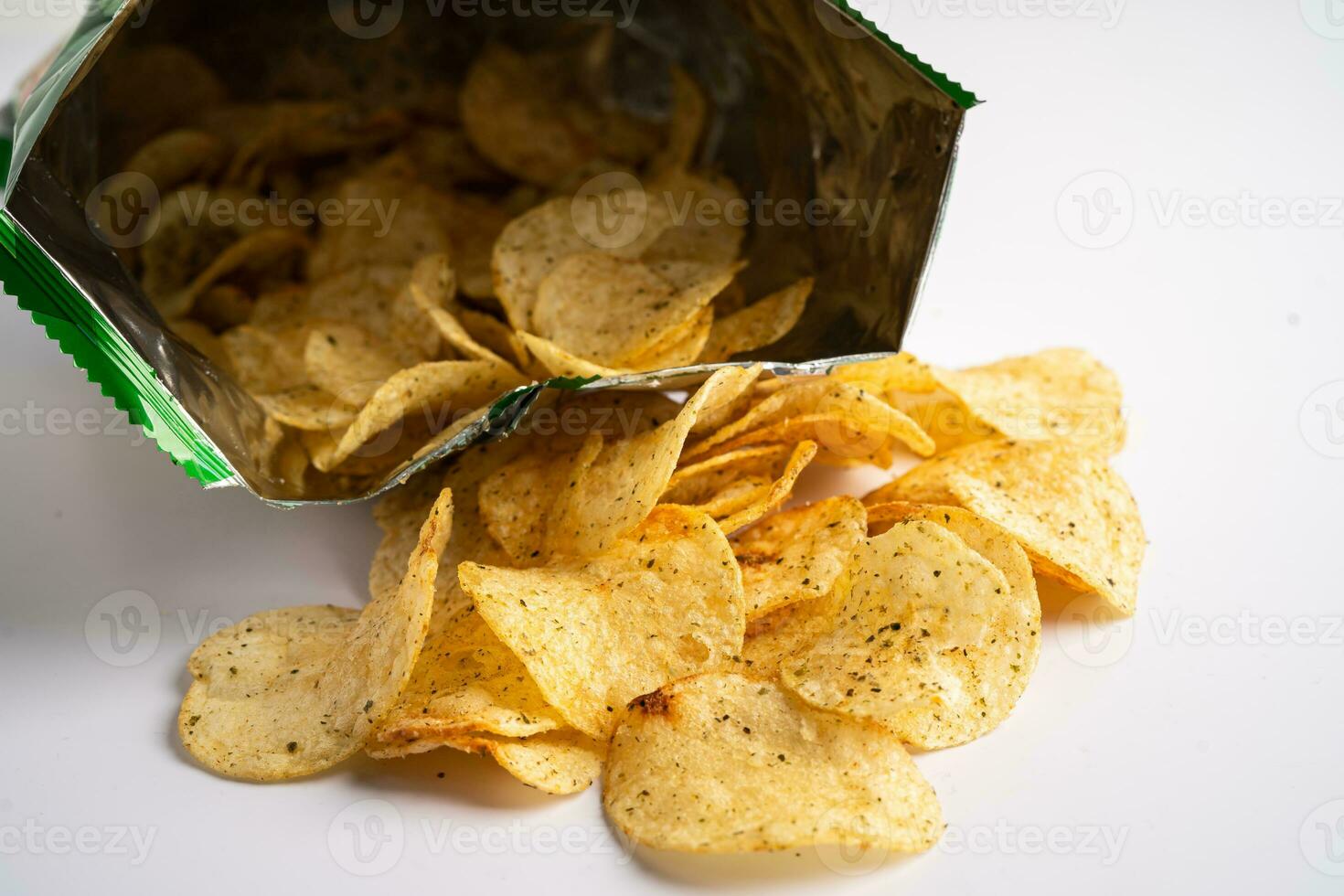 Potato chips, delicious spicy for crips, thin slice deep fried snack fast food in open bag. photo