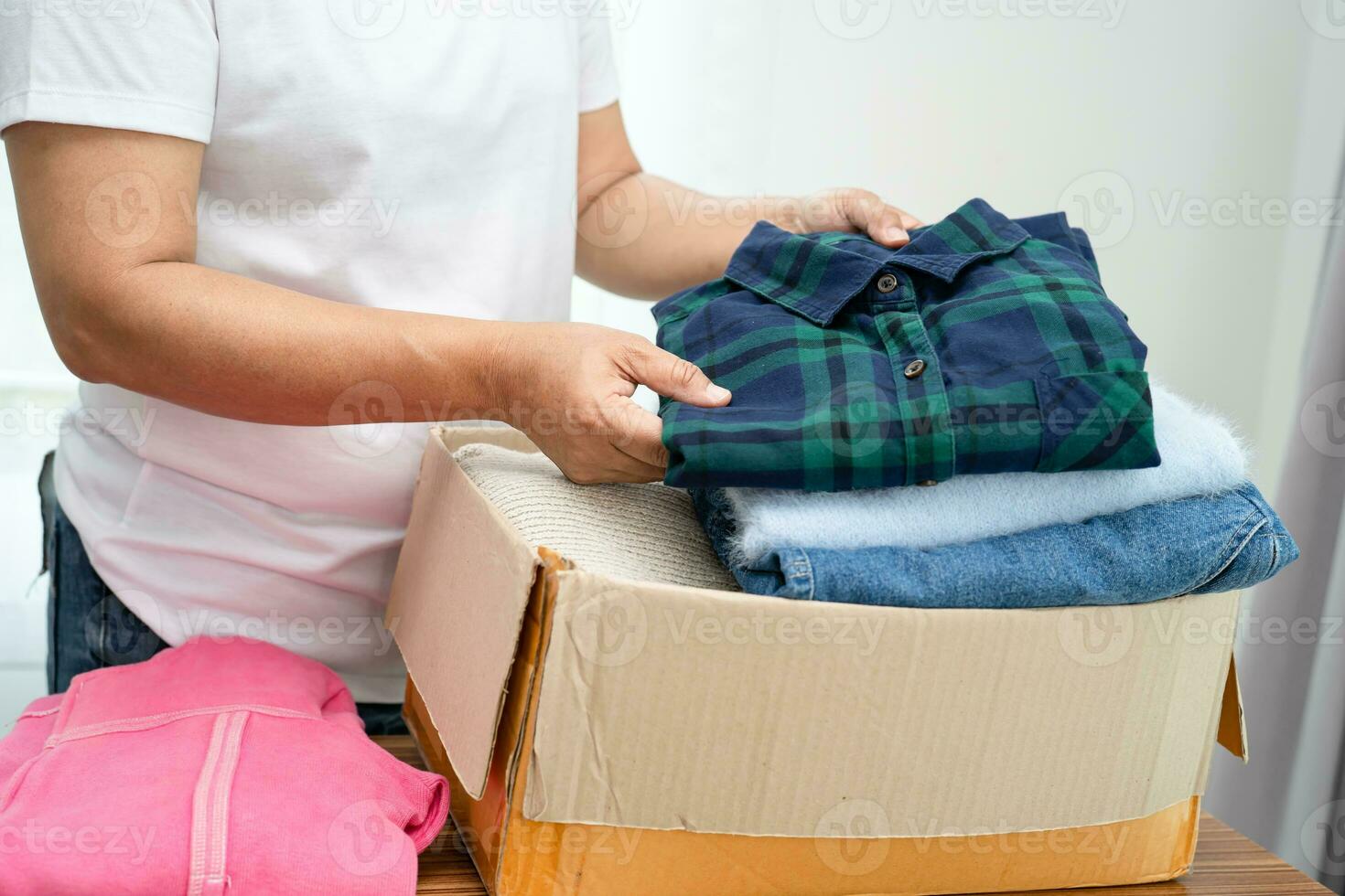 Donation box with used clothes at home to support help for poor people in the world. photo