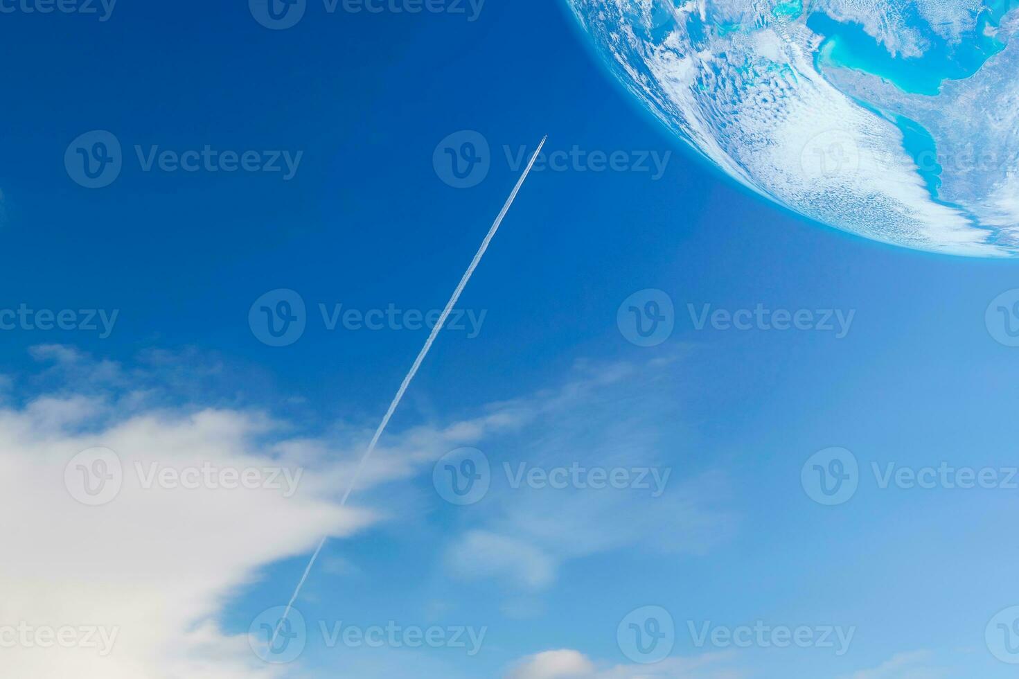 A private jet plane flying with contrail or vapor trails heading to the planet on blue sky photo