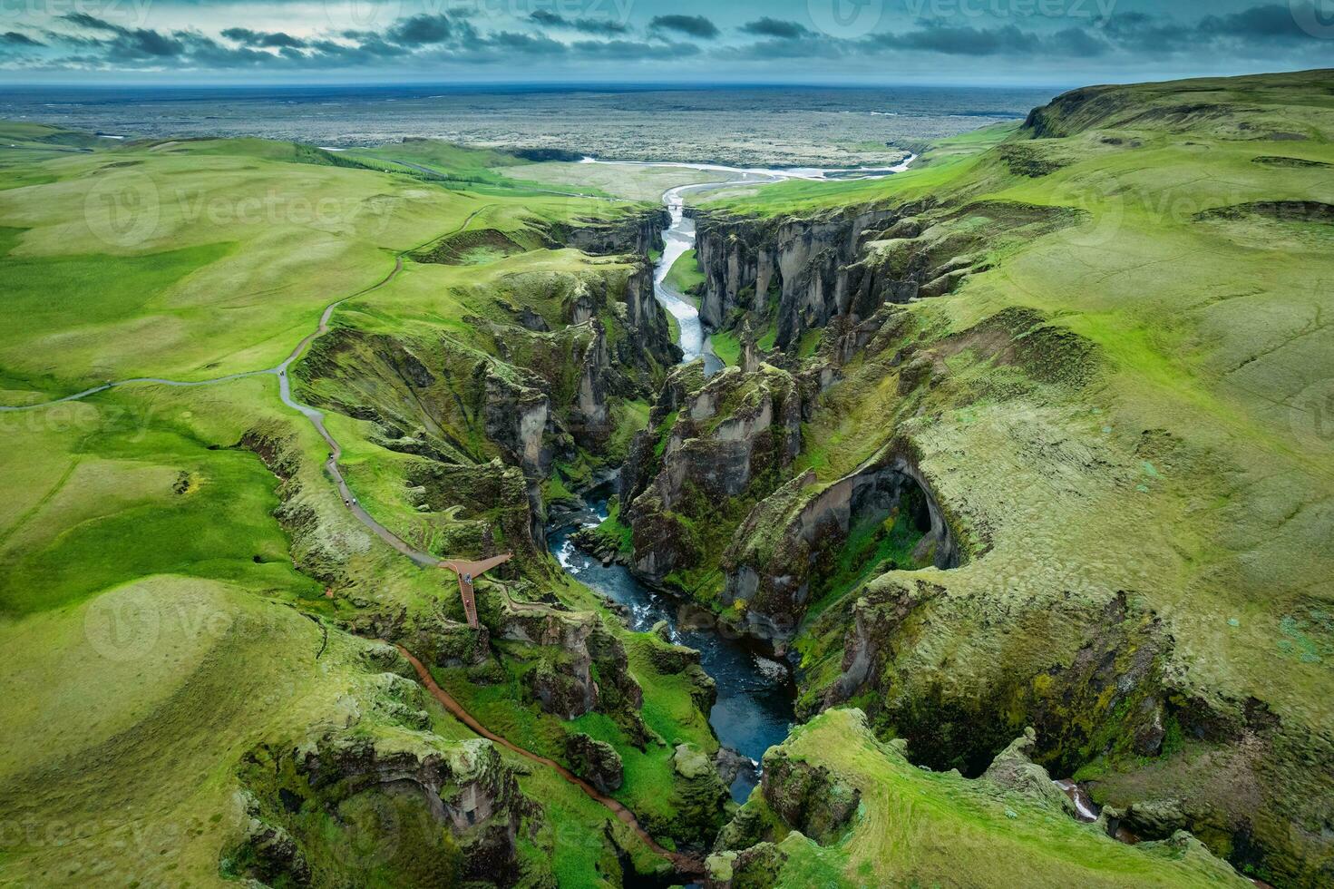 Stunning view of Fjadrargljufur canyon naturally eroded with Fjadra flowing through ravine in summer at Iceland photo