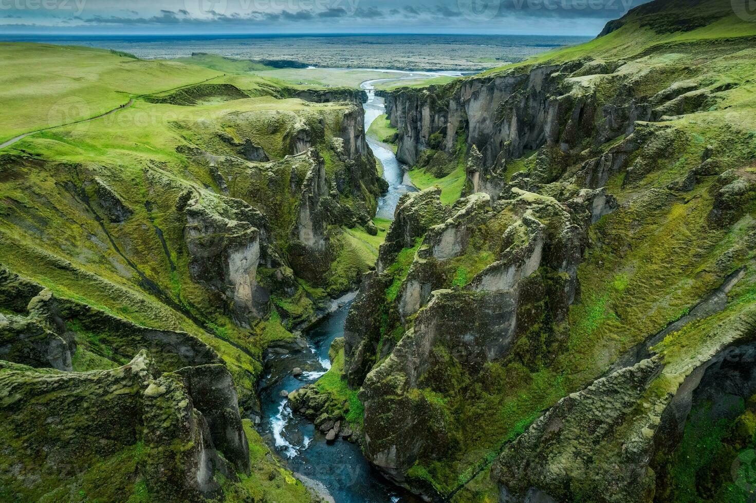 Stunning view of Fjadrargljufur canyon naturally eroded with Fjadra flowing through ravine in summer at Iceland photo