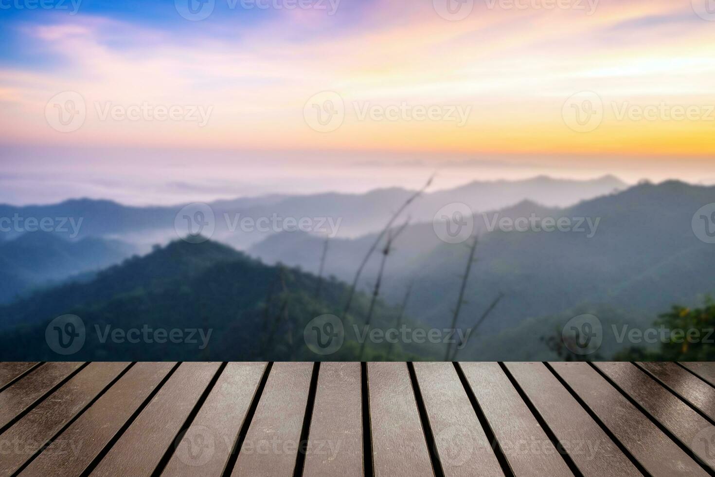 Wood table top on blurred mountain fog scenic sunrise photo